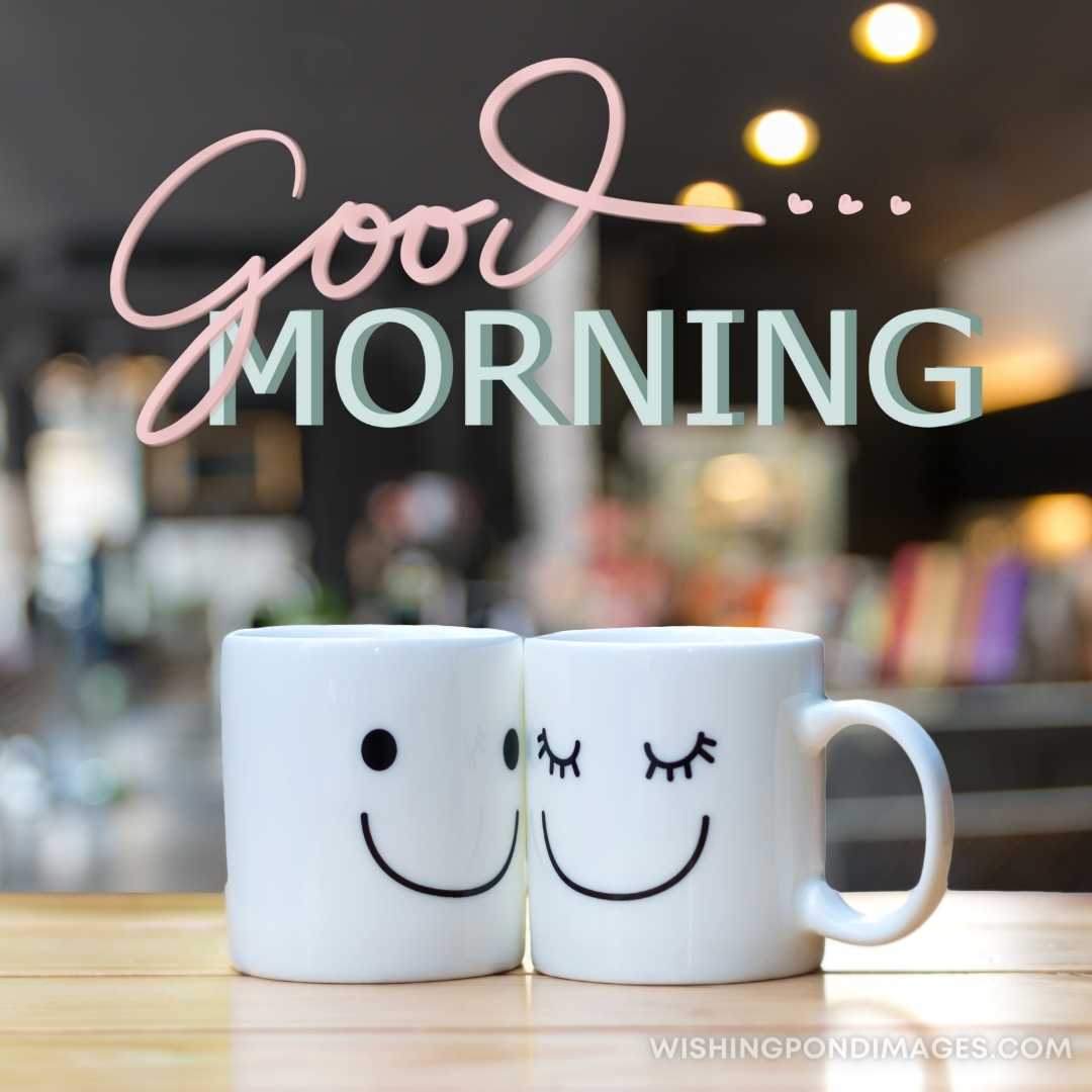 Two happy cups on coffee store blur background. Good Morning Coffee Images